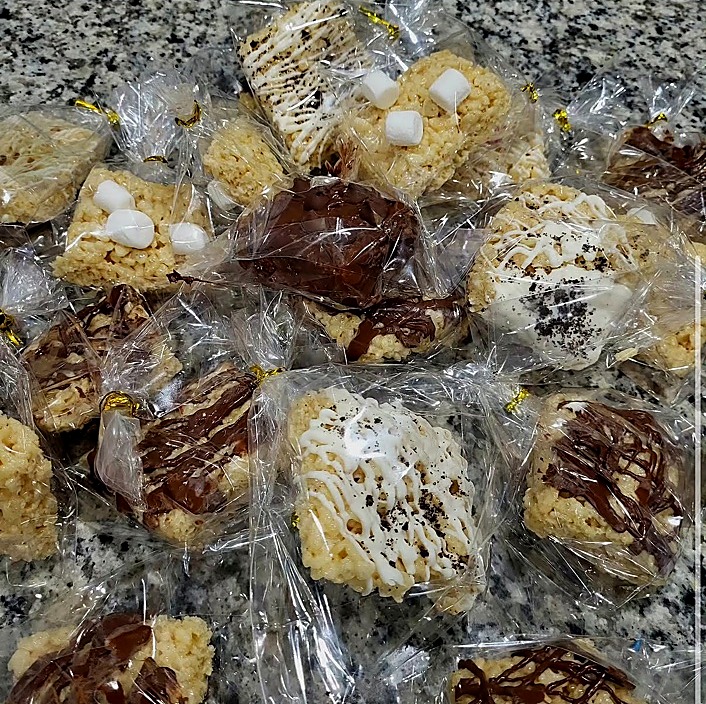 Individually wrapped crispy cereal treats with chocolate and cream-colored drizzles